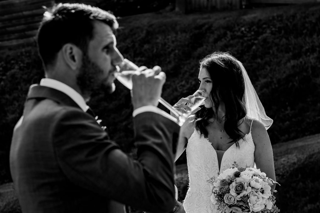 bride and groom drinking champagne at sandy cove elopement