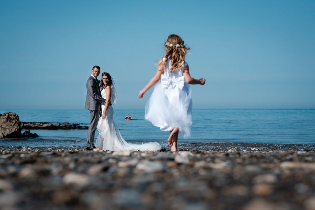 bridesmaid running on beach in ilfracombe