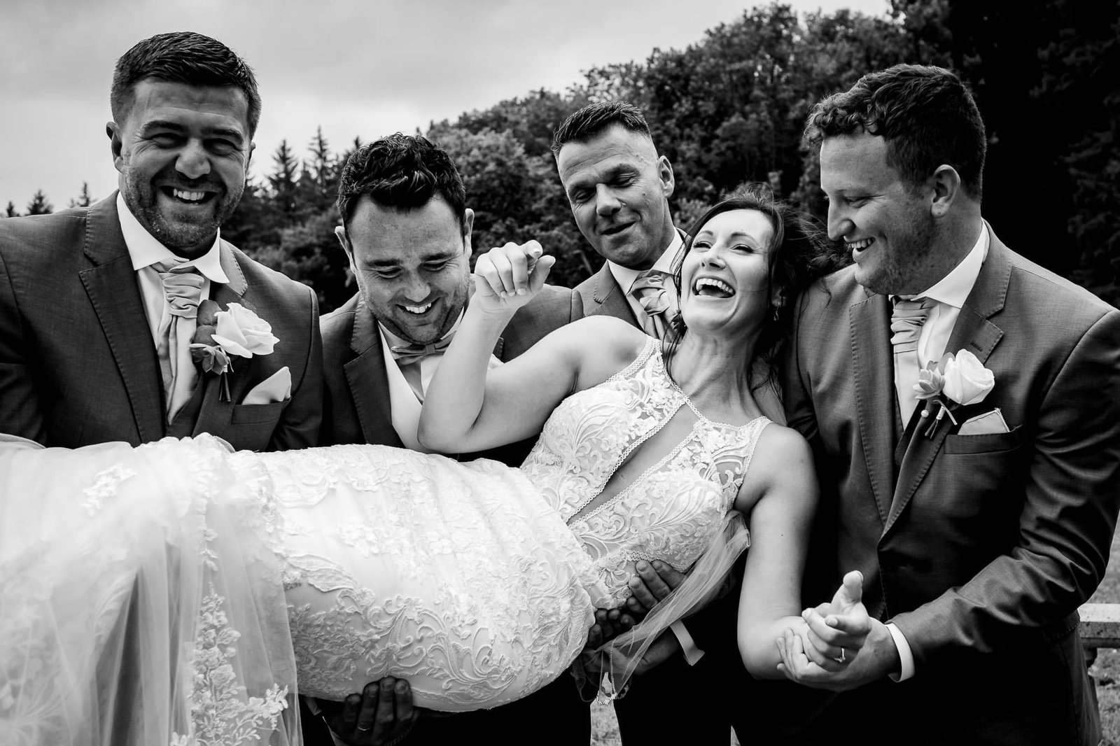 Groomsmen picking up bride at Tawstock Court wedding